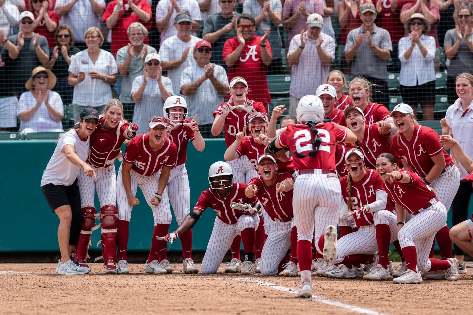 Alabama Crimson Tide softball players celebrating a play on the field